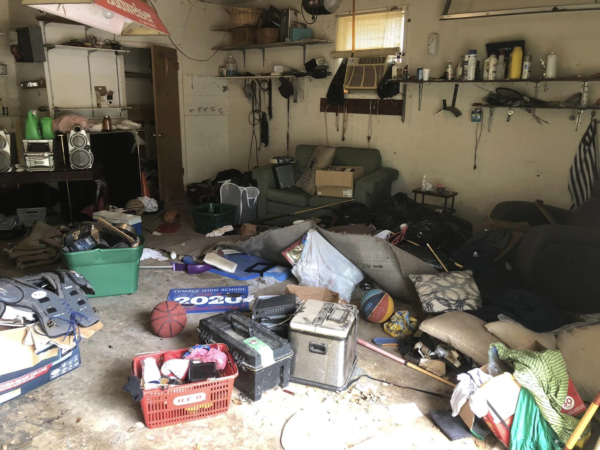 Messy room with furniture, storage, and various clutter.